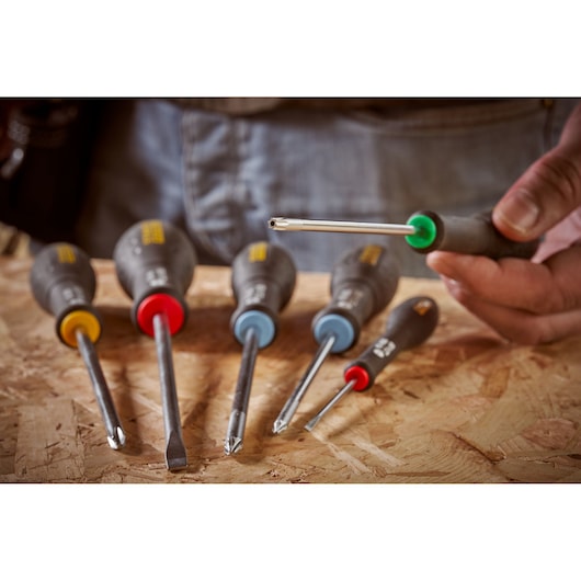 Photo of STANLEY 0-65-396 screwdriver set with color-coded handles on a wooden surface.