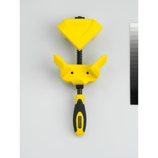 STANLEY 0-83-122 corner clamp tool, yellow and black, flat lay angle.