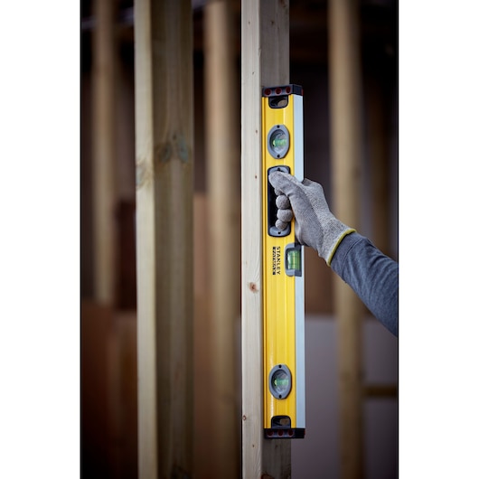 Photo of STANLEY 1-43-524 spirit level being used in vertical position on wood frame.