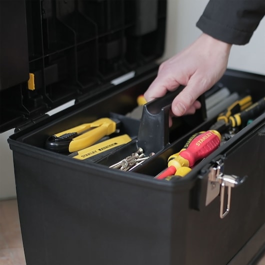 STANLEY 1-93-968 toolbox photography showing organized tools and screws with a hand lifting the tray.