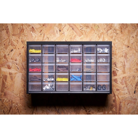 STANLEY 1-93-980 organizer with 24 clear drawers holding assorted hardware, wall mounted front view.