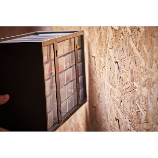 STANLEY 1-93-980 wall-mounted small parts organizer with clear drawers, angled side view.