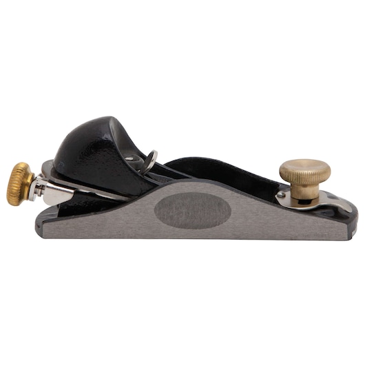 STANLEY block plane side view on white background, featuring a metal body and brass adjustment knobs