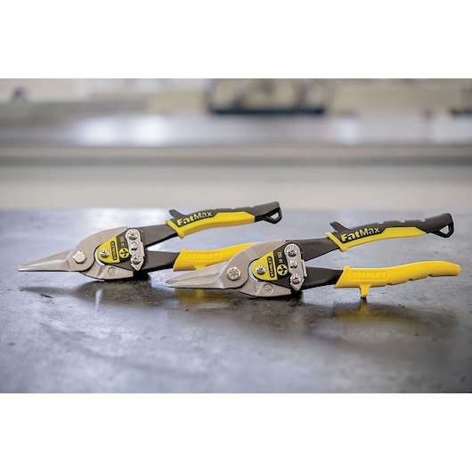 STANLEY 14-563 aviation snips with yellow and black FatMax handles on a workshop table, product photography.