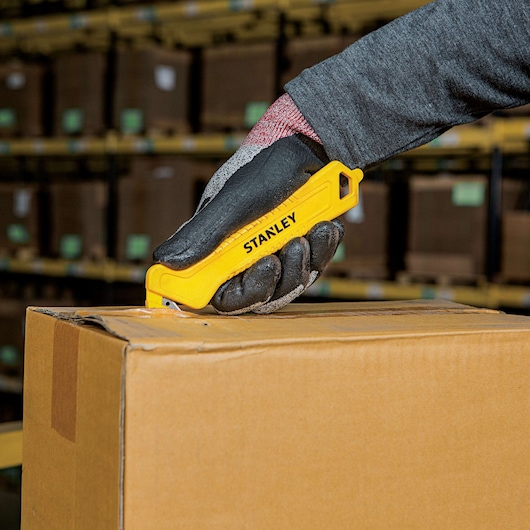 Single Sided Pull Cutter being used for opening package.