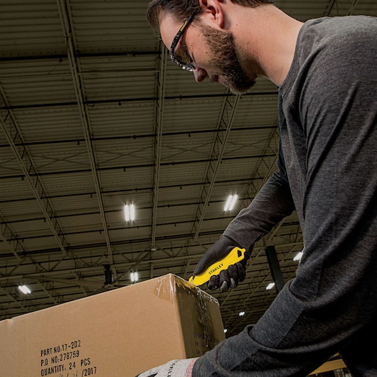 Double Sided Pull Cutter being used for opening package.