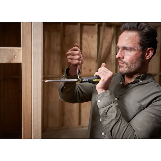 STANLEY FMHT0-62623 screwdriver in use for woodworking, close-up photo, product held in hand.