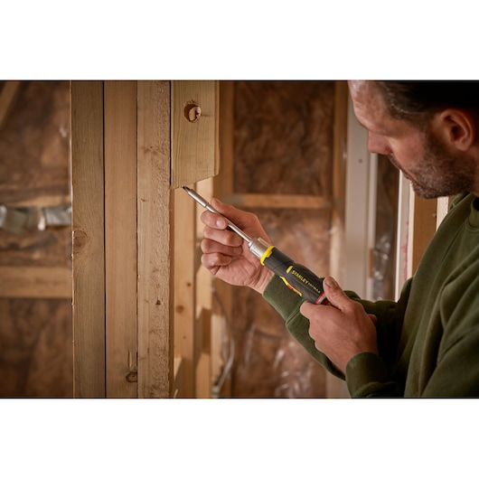 Photo of STANLEY FMHT0-62691 screwdriver used on wooden frame in construction setting.