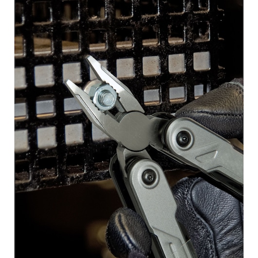 STANLEY FMHT0-72414 multi-tool pliers gripping a bolt, close-up view with gloved hand.