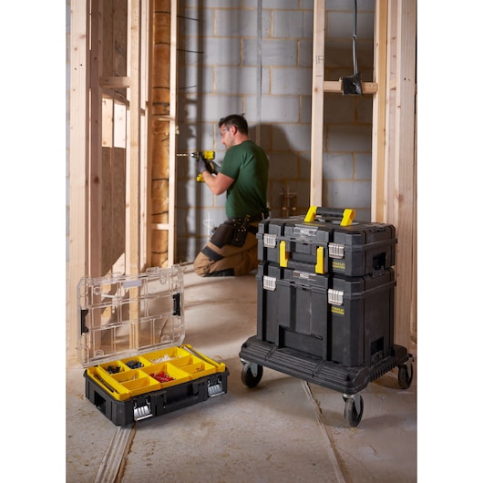 STANLEY FMST1-71966 mobile tool storage stack and organizer box with yellow handles on construction site.