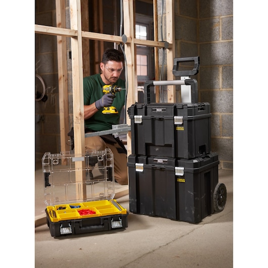 STANLEY FMST1-75753 stackable toolbox set and organizer box in jobsite, black with yellow compartments.