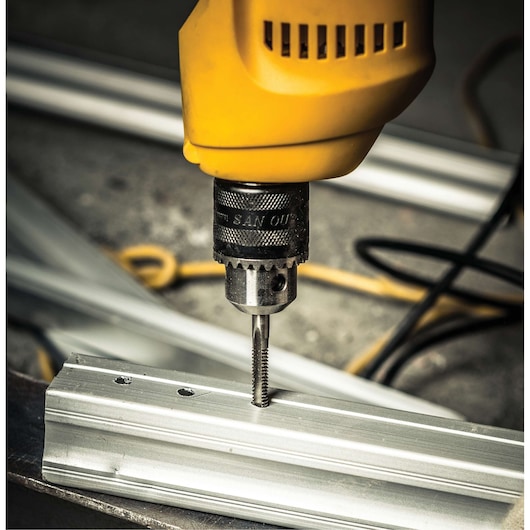 Stanley STDR5510 drill close-up tapping thread in metal bar, photography product.