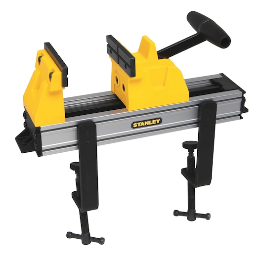 STANLEY bench vise with yellow grips, black handle, silver body, and black clamps, front angle on white background