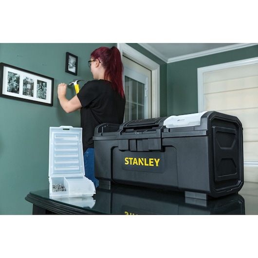 STANLEY STST19420 black toolbox with yellow logo on table, open organizer box with hardware beside it, indoor room background.