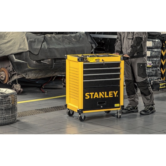 Man pushing 7 drawers metal roller cabinet using handle on the side